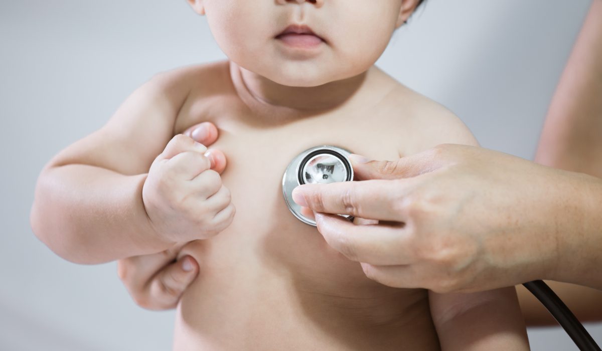 Doctor examining asian baby girl and listen her heart beat with stethoscope in the hospital